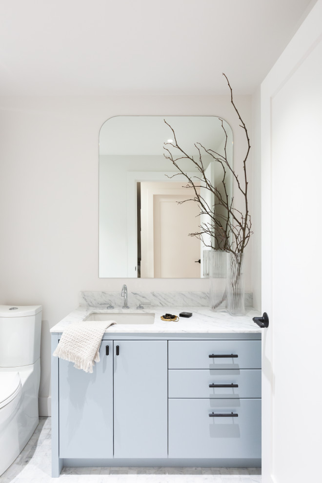 Photo of a contemporary cloakroom in Vancouver with flat-panel cabinets, blue cabinets, white walls, white floors, white worktops and a built in vanity unit.