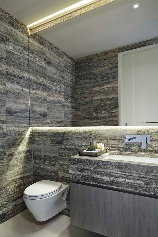 Photo of a contemporary cloakroom in New York with flat-panel cabinets, a wall mounted toilet, multi-coloured tiles and a submerged sink.