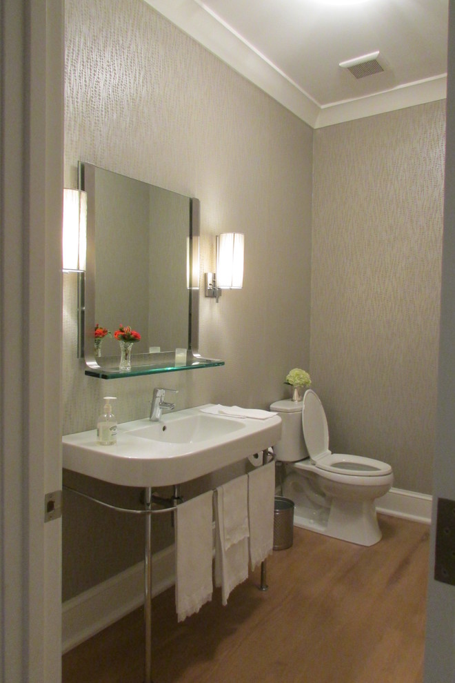 Moderne Gästetoilette mit Waschtischkonsole, grauer Wandfarbe und hellem Holzboden in New Orleans