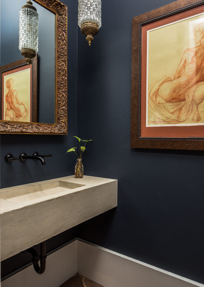 チャールストンにある地中海スタイルのおしゃれなトイレ・洗面所 (一体型シンク、コンクリートの洗面台、青い壁) の写真