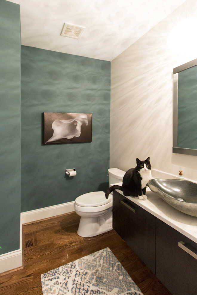Inspiration for a small contemporary dark wood floor and brown floor powder room remodel in Cincinnati with flat-panel cabinets, dark wood cabinets, a one-piece toilet, green walls and quartzite countertops