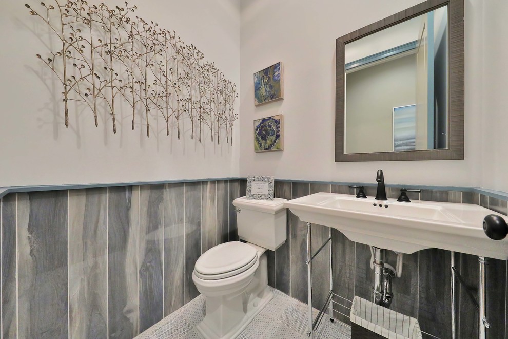 Small nautical cloakroom in Jacksonville with a two-piece toilet, blue tiles, ceramic tiles, cement flooring, a pedestal sink and blue floors.