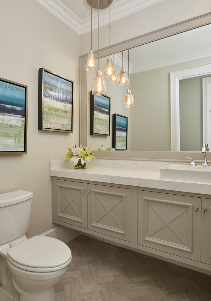 Medium sized classic cloakroom in Grand Rapids with freestanding cabinets, beige cabinets, a one-piece toilet, marble flooring, a vessel sink, engineered stone worktops, grey floors, white worktops, a floating vanity unit and a vaulted ceiling.