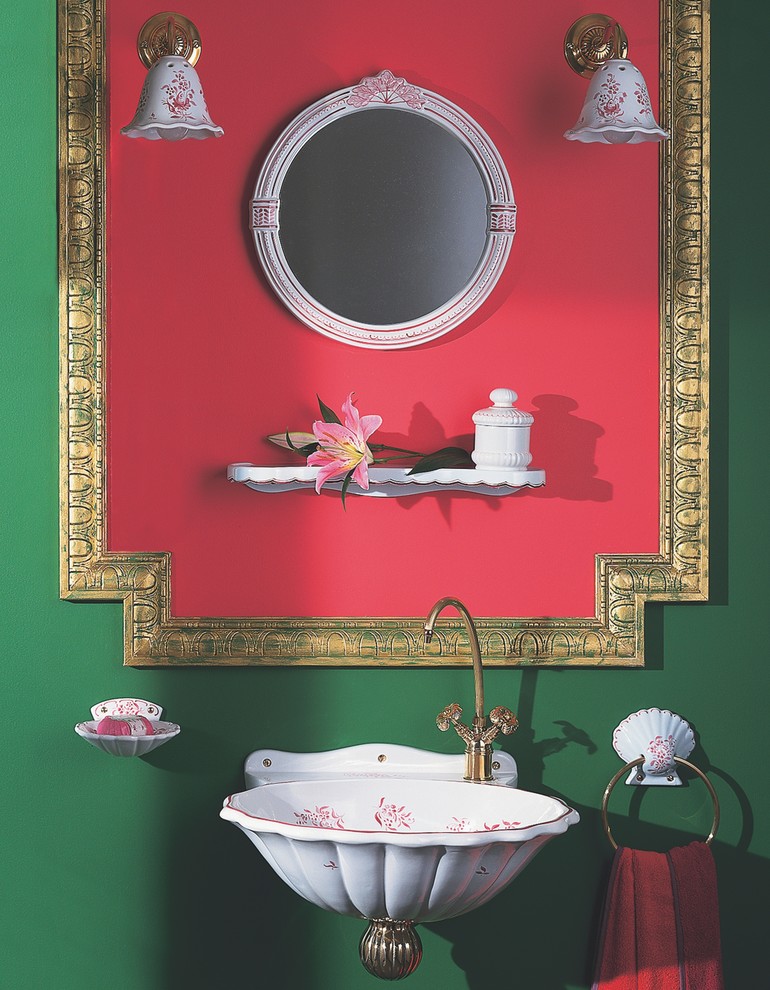 This is an example of a small world-inspired cloakroom in Miami with a wall-mounted sink and green walls.