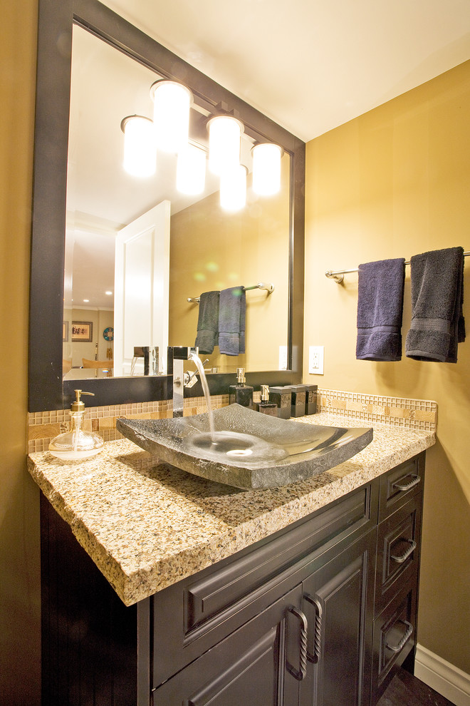 Example of a small classic brown tile and mosaic tile powder room design in Vancouver with a vessel sink, raised-panel cabinets, medium tone wood cabinets, granite countertops, a one-piece toilet and beige walls