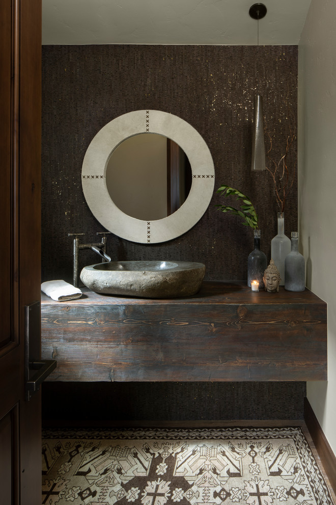 На фото: туалет в стиле рустика с коричневыми стенами, настольной раковиной, столешницей из дерева и коричневой столешницей