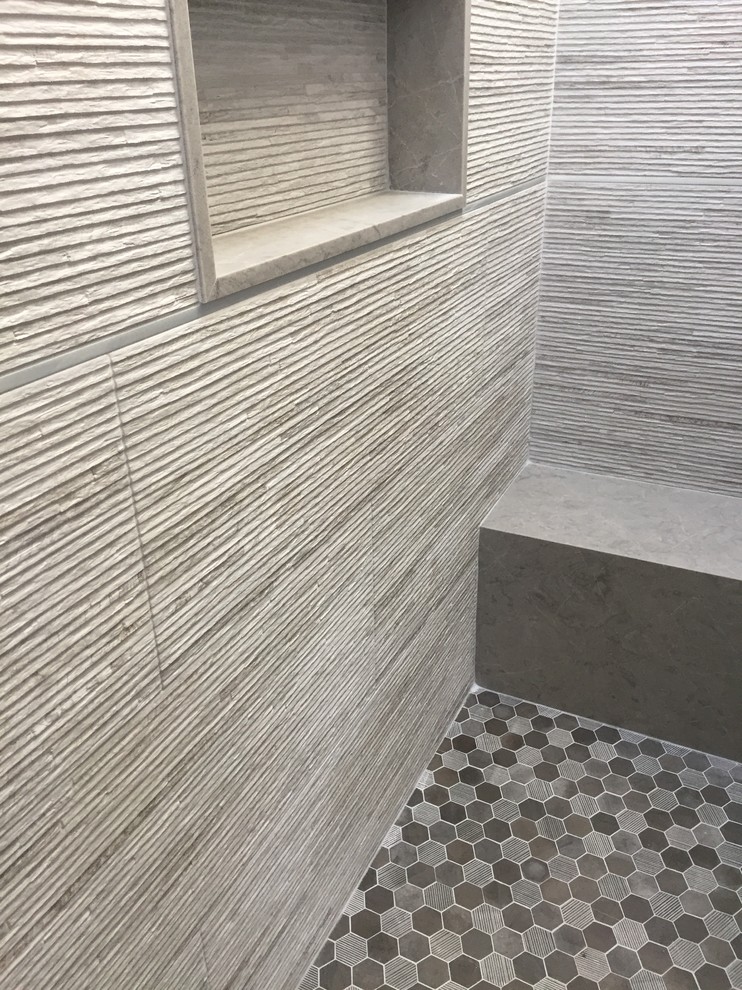 Inspiration for a mid-sized contemporary white tile and porcelain tile ceramic tile and black floor bathroom remodel in Orange County with flat-panel cabinets, gray cabinets, a one-piece toilet, white walls, a vessel sink and quartz countertops