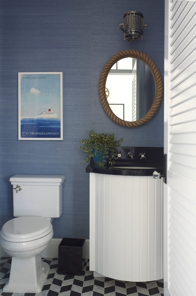 Photo of a small beach style cloakroom in San Diego with a submerged sink, white cabinets, engineered stone worktops, blue walls, marble flooring, a two-piece toilet and black and white tiles.