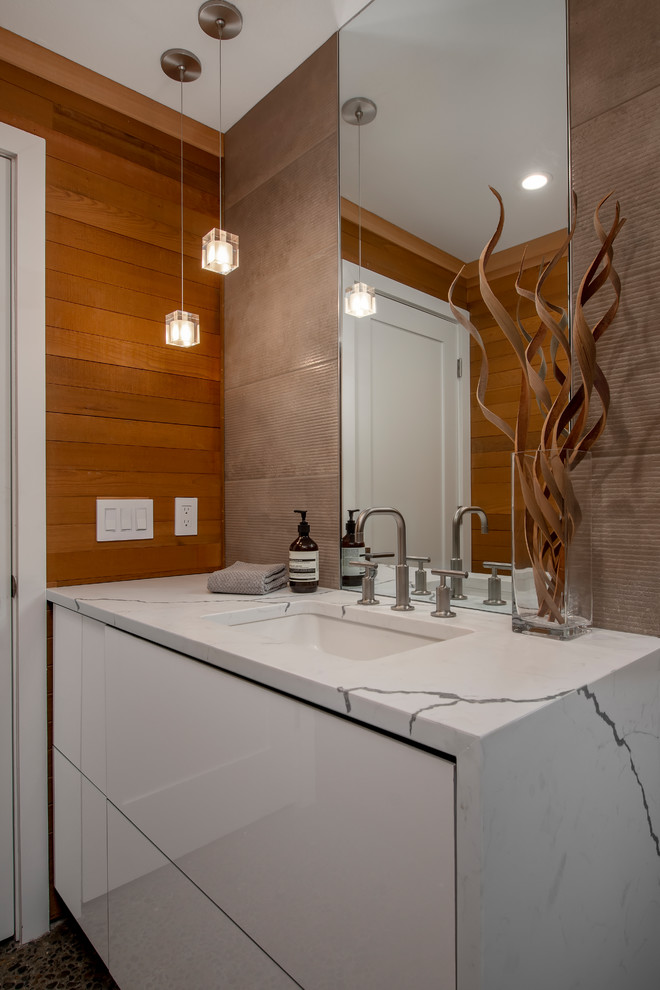 Idéer för ett litet modernt vit toalett, med släta luckor, vita skåp, en toalettstol med hel cisternkåpa, brun kakel, porslinskakel, bruna väggar, betonggolv, ett undermonterad handfat, bänkskiva i kvarts och flerfärgat golv