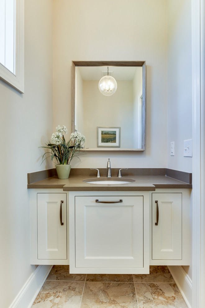 Inspiration for a medium sized classic cloakroom in Minneapolis with recessed-panel cabinets, white cabinets, a one-piece toilet, beige walls, porcelain flooring, a submerged sink and engineered stone worktops.