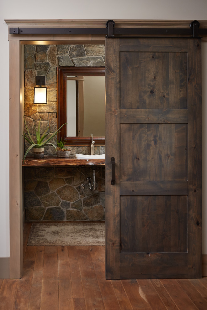Rustikale Gästetoilette mit Aufsatzwaschbecken, Waschtisch aus Holz, grauer Wandfarbe, braunem Holzboden und brauner Waschtischplatte in Grand Rapids