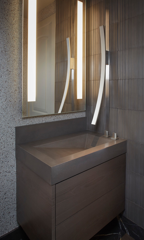 Photo of a medium sized contemporary cloakroom in Sacramento with flat-panel cabinets, brown cabinets, a one-piece toilet, brown tiles, cement tiles, grey walls, marble flooring, an integrated sink, concrete worktops and black floors.