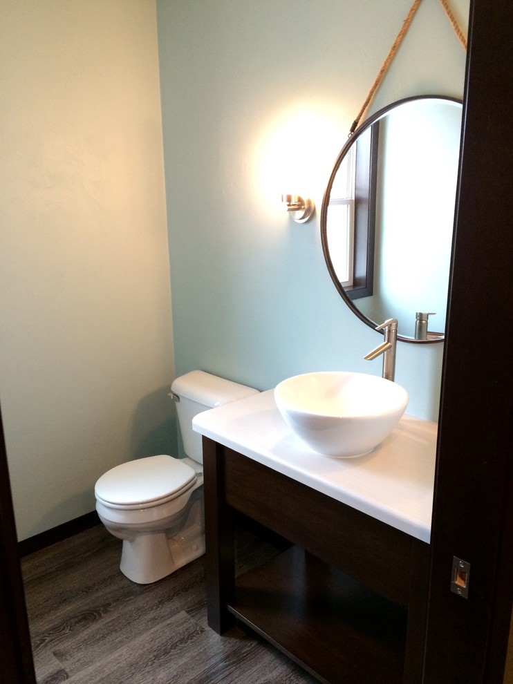 Inspiration pour un WC et toilettes craftsman en bois foncé de taille moyenne avec une vasque, un placard en trompe-l'oeil, un plan de toilette en stratifié et un sol en vinyl.