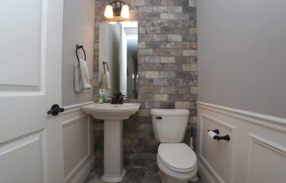 Mid-sized transitional multicolored tile and subway tile multicolored floor powder room photo in Chicago with a two-piece toilet, gray walls and a pedestal sink