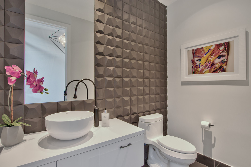 This is an example of a medium sized contemporary cloakroom in Phoenix with flat-panel cabinets, white cabinets, a one-piece toilet, brown tiles, white walls, a vessel sink, engineered stone worktops and white worktops.