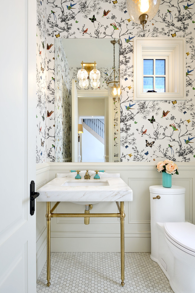 Small elegant marble floor and white floor powder room photo in Toronto with a one-piece toilet, multicolored walls, a console sink, furniture-like cabinets and marble countertops