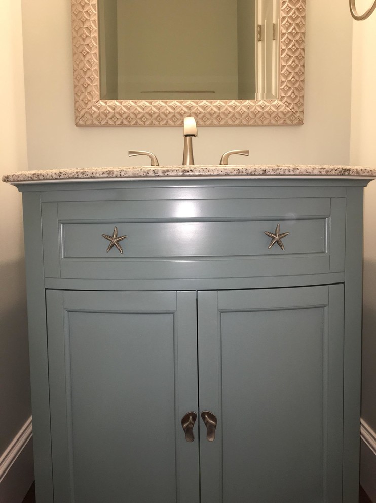 Powder room - mid-sized coastal dark wood floor powder room idea in Orange County with shaker cabinets, blue cabinets, beige walls, an undermount sink and granite countertops
