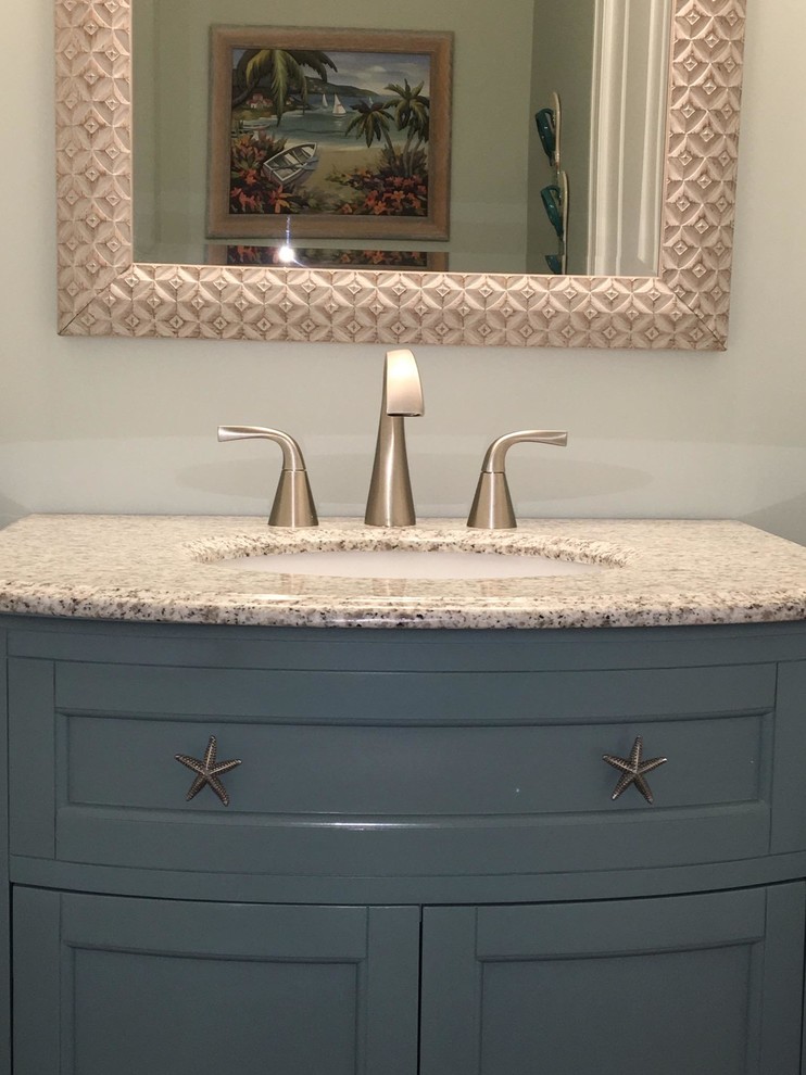 Example of a mid-sized beach style dark wood floor powder room design in Orange County with shaker cabinets, blue cabinets, beige walls, an undermount sink and granite countertops