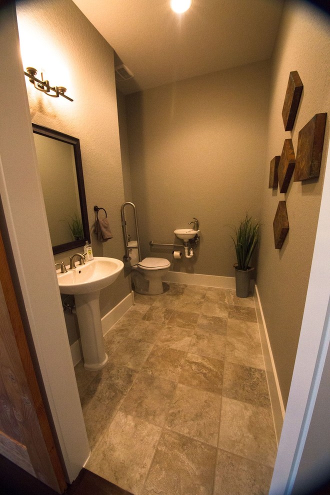 Inspiration for a large rural cloakroom in Austin with a one-piece toilet, beige tiles, ceramic tiles, brown walls, ceramic flooring and a pedestal sink.
