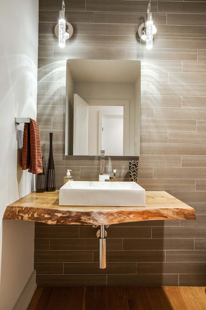 Trendy powder room photo in Dallas with a vessel sink and brown countertops
