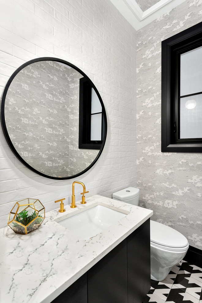 Inspiration for a small modern white tile and subway tile porcelain tile and white floor powder room remodel in Vancouver with flat-panel cabinets, black cabinets, a two-piece toilet, gray walls, an undermount sink, quartz countertops and white countertops