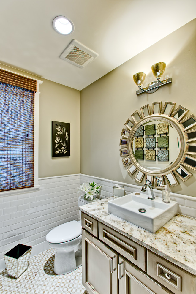 Transitional white tile and subway tile powder room photo in Denver with a vessel sink, recessed-panel cabinets, a two-piece toilet, beige walls and beige countertops