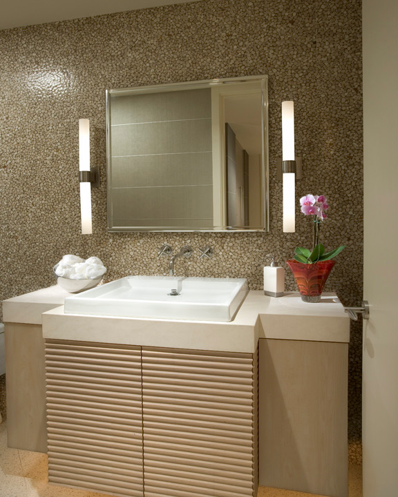 Inspiration for a small contemporary beige tile powder room remodel in Phoenix with a vessel sink, flat-panel cabinets, light wood cabinets and limestone countertops