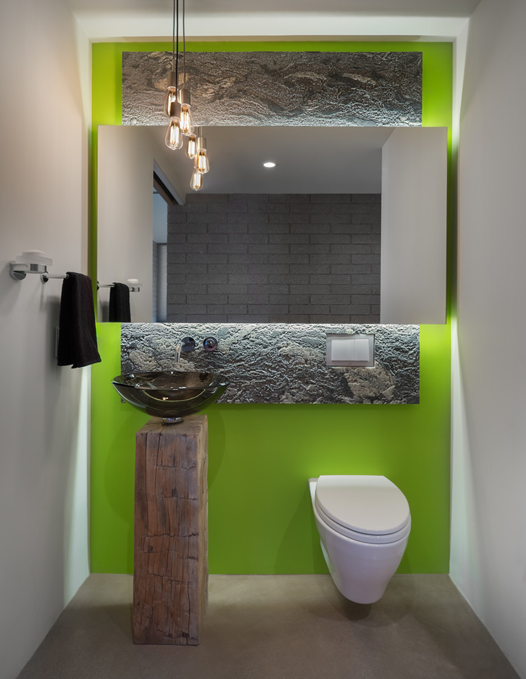 Trendy powder room photo in Phoenix with a vessel sink, a wall-mount toilet and green walls