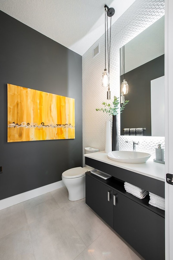 Photo of a modern cloakroom in Edmonton with flat-panel cabinets, a one-piece toilet, white tiles, grey walls, porcelain flooring, a vessel sink, grey floors and white worktops.
