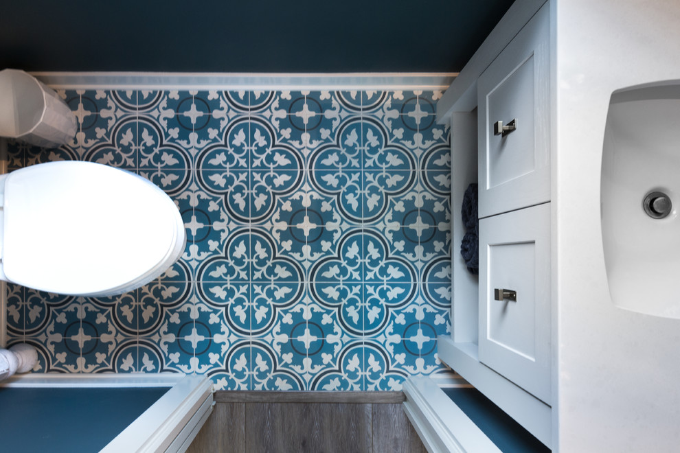 Cottage cement tile floor and turquoise floor powder room photo in Other with flat-panel cabinets, turquoise cabinets, quartzite countertops and white countertops