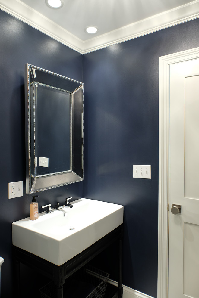 Inspiration for a mid-sized transitional powder room remodel in San Francisco with open cabinets, blue cabinets, a two-piece toilet, blue walls and an integrated sink