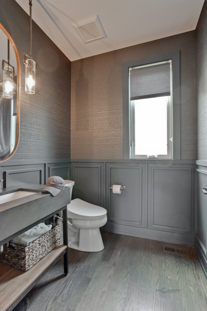 This is an example of a traditional cloakroom in Chicago with grey walls, dark hardwood flooring, a submerged sink, brown floors, grey worktops, a freestanding vanity unit, wainscoting, wallpapered walls and wood walls.