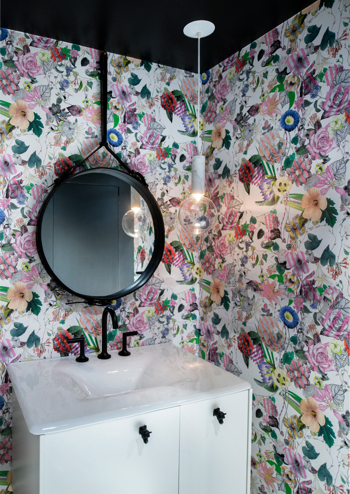 Trendy powder room photo in Atlanta with flat-panel cabinets, white cabinets, multicolored walls and an integrated sink