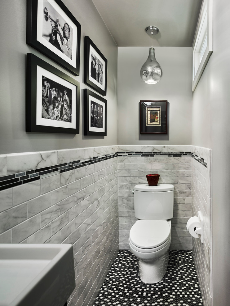Small contemporary cloakroom in Philadelphia with a wall-mounted sink, a two-piece toilet, multi-coloured tiles, grey walls and ceramic flooring.