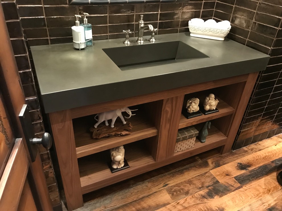Inspiration for a modern medium tone wood floor and multicolored floor powder room remodel in Phoenix with open cabinets, brown cabinets and concrete countertops