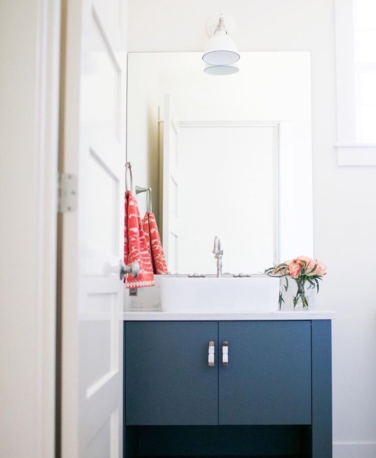 Small country cloakroom in Portland with flat-panel cabinets, blue cabinets, a two-piece toilet, white walls, light hardwood flooring, a vessel sink, marble worktops and grey worktops.