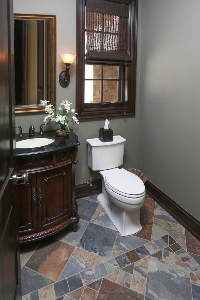 Small traditional cloakroom in Detroit with freestanding cabinets, dark wood cabinets, grey walls, slate flooring and solid surface worktops.