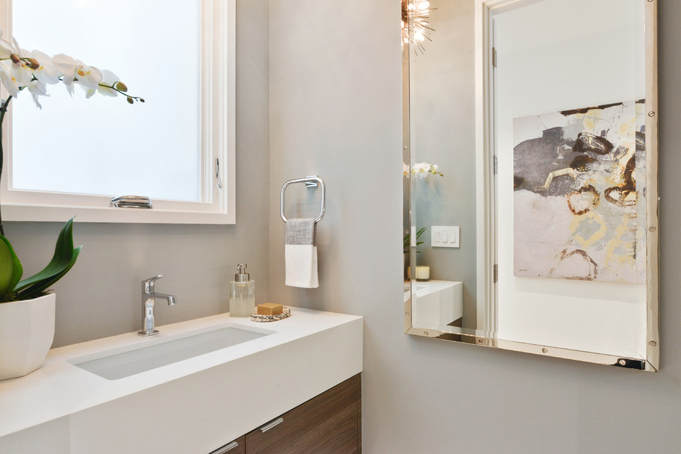 Inspiration for a small contemporary powder room remodel in San Francisco with flat-panel cabinets, medium tone wood cabinets, quartz countertops and an undermount sink