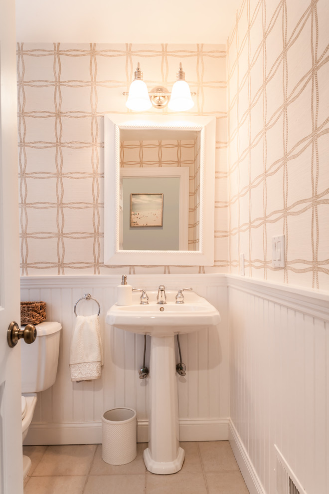 Photo of a medium sized coastal cloakroom in New York with a two-piece toilet, beige tiles, porcelain tiles, beige walls and porcelain flooring.