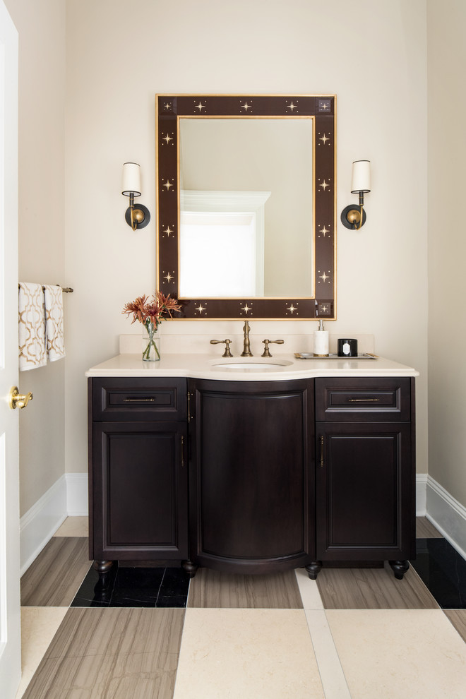 ワシントンD.C.にあるトラディショナルスタイルのおしゃれなトイレ・洗面所 (家具調キャビネット、濃色木目調キャビネット、ベージュの壁、アンダーカウンター洗面器、マルチカラーの床、ベージュのカウンター) の写真