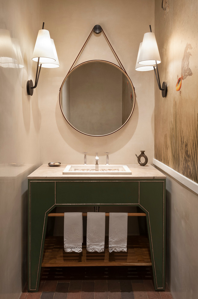 Ispirazione per un bagno di servizio design con lavabo da incasso e consolle stile comò