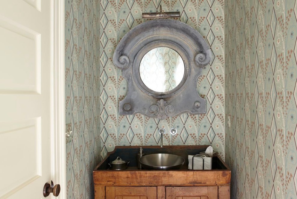 ニューヨークにある小さなシャビーシック調のおしゃれなトイレ・洗面所 (家具調キャビネット、ヴィンテージ仕上げキャビネット、マルチカラーの壁、ベッセル式洗面器、木製洗面台) の写真