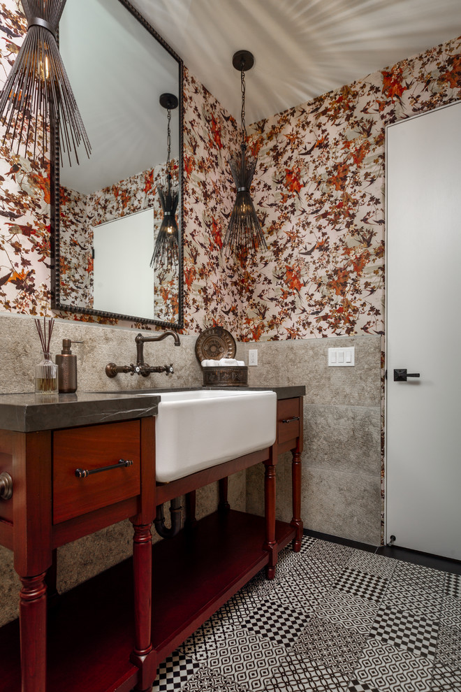 Powder room - eclectic gray tile black floor powder room idea in Las Vegas with flat-panel cabinets, dark wood cabinets, multicolored walls, a drop-in sink and gray countertops