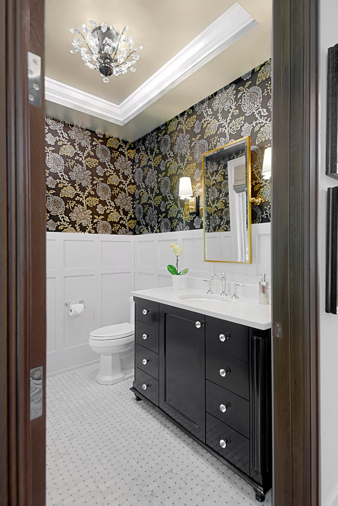 This is an example of a medium sized classic cloakroom in Grand Rapids with black cabinets, white worktops, a freestanding vanity unit, shaker cabinets, multi-coloured walls, mosaic tile flooring, a submerged sink, white floors, a drop ceiling, wainscoting, wallpapered walls, a two-piece toilet and engineered stone worktops.