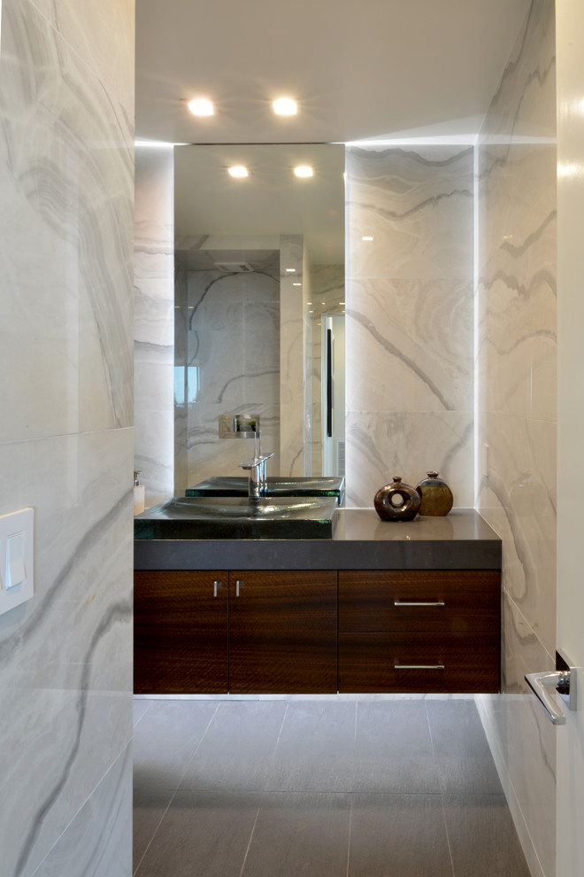 Design ideas for a medium sized modern cloakroom in San Diego with flat-panel cabinets, dark wood cabinets, multi-coloured tiles, stone tiles, multi-coloured walls, porcelain flooring, a built-in sink and engineered stone worktops.