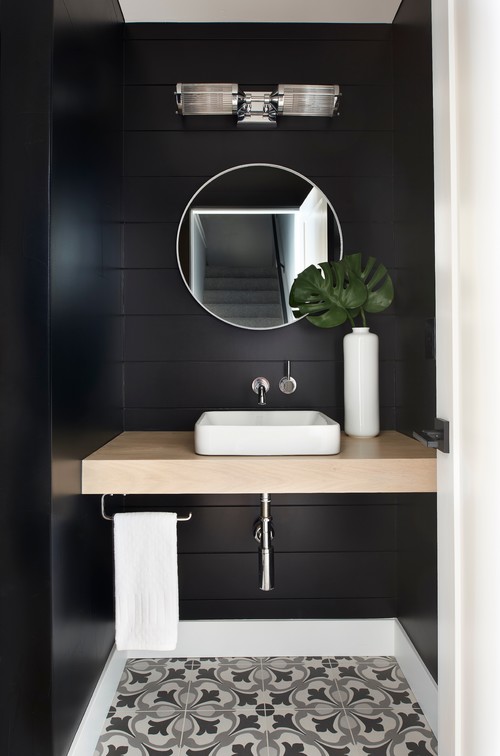 Mid-sized transitional porcelain tile and multicolored floor powder room photo in Denver with black walls, a vessel sink and wood countertops