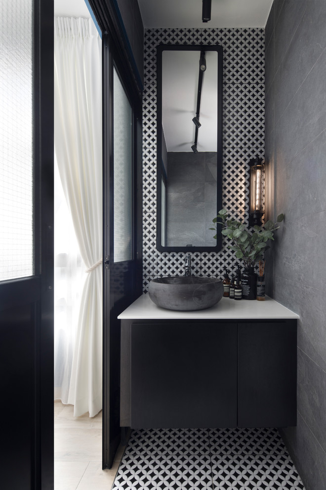 Inspiration for a small scandinavian black and white tile multicolored floor powder room remodel in Singapore with flat-panel cabinets, black cabinets, gray walls, a vessel sink and white countertops