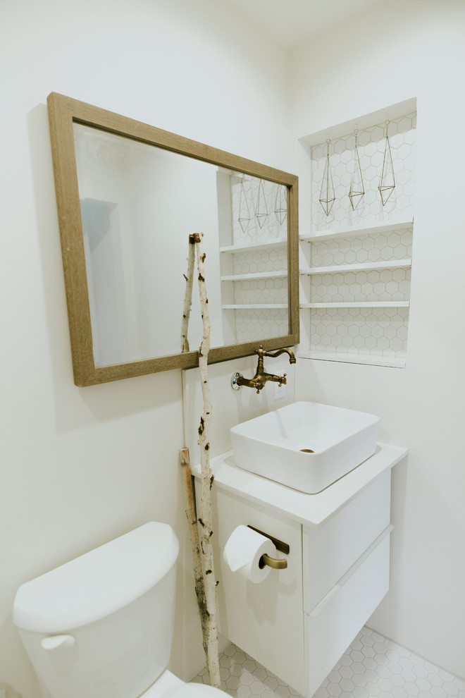 Powder room - small scandinavian white tile ceramic tile and white floor powder room idea in Phoenix with white walls, flat-panel cabinets, white cabinets, a one-piece toilet, a vessel sink, quartz countertops and white countertops