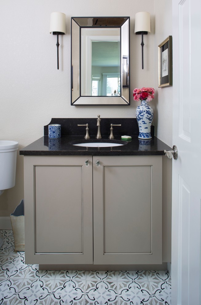 Example of a small transitional ceramic tile and multicolored floor powder room design in Denver with shaker cabinets, beige cabinets, beige walls, an undermount sink, quartz countertops and black countertops