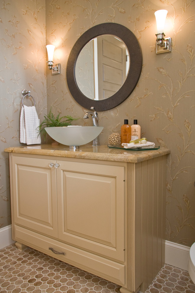 Powder room - mid-sized traditional ceramic tile powder room idea in Grand Rapids with raised-panel cabinets, beige cabinets, beige walls, a vessel sink and granite countertops